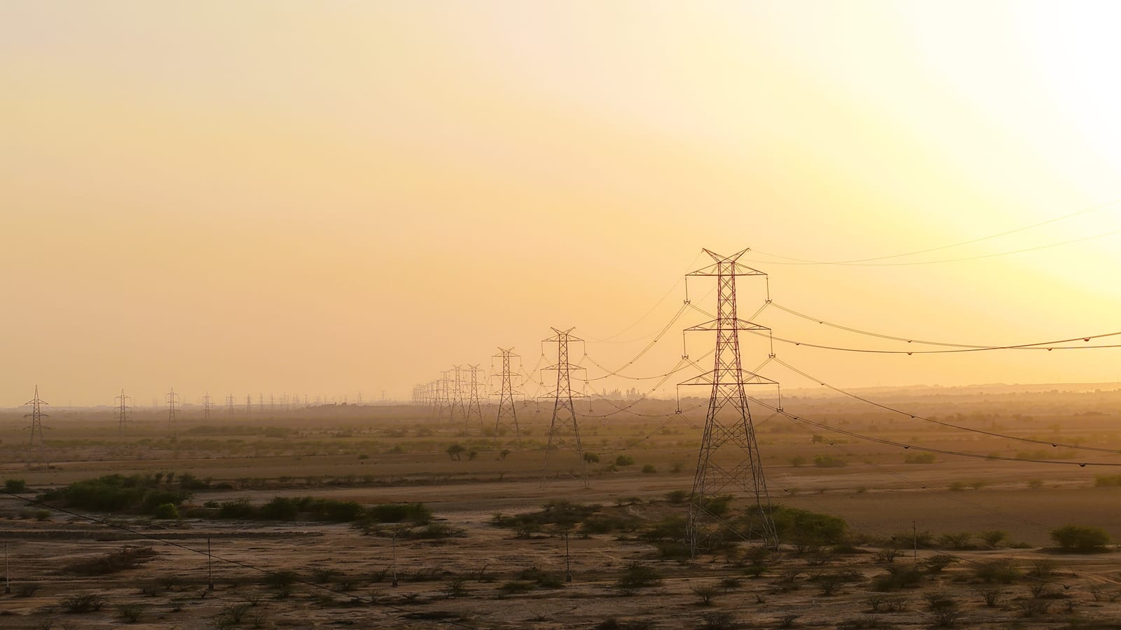 High-tension transmission line and lattice towers across open terrain