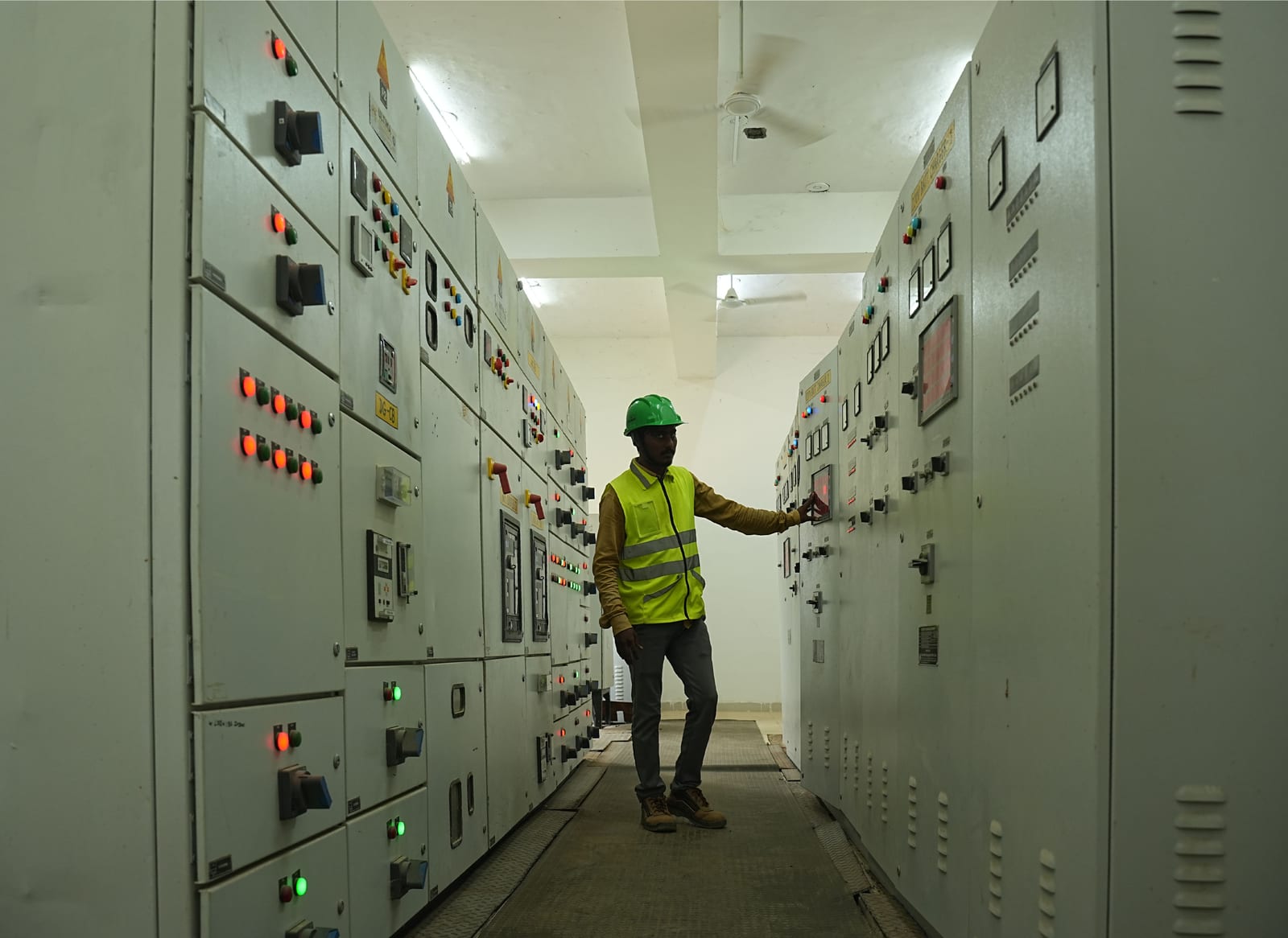 Engineer at the control panels of a modular substation
